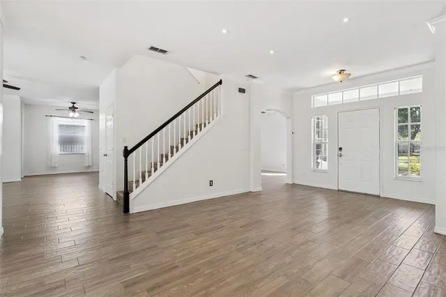 a view of an entryway with wooden floor