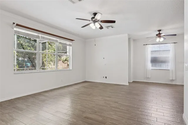 wooden floor in an empty room with a window