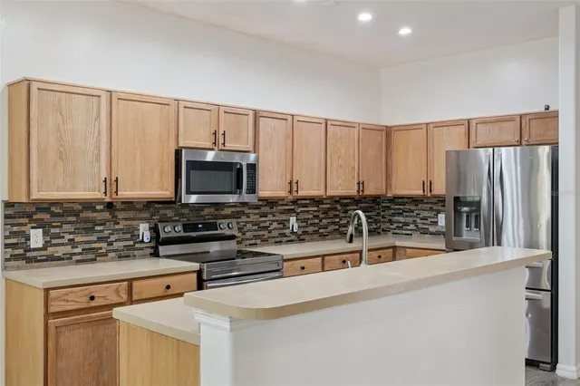 a kitchen with stainless steel appliances a stove and a refrigerator