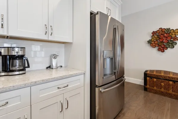 a kitchen with stainless steel appliances granite countertop a refrigerator and a sink