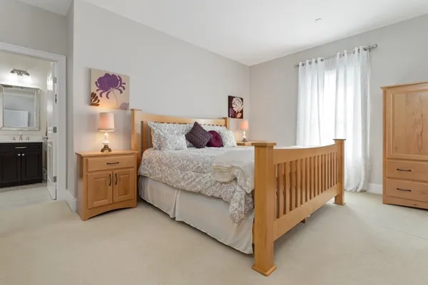 a bedroom with a bed and dresser