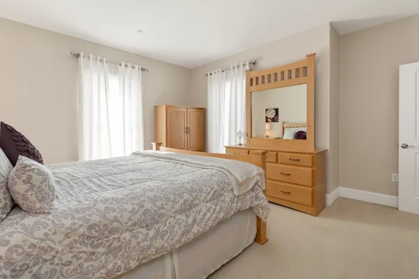 a bedroom with a bed and dresser