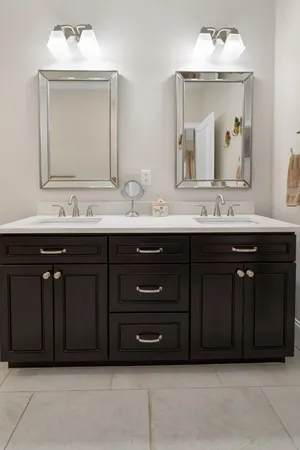 a bathroom with a sink double vanity and a mirror