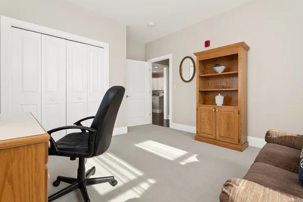 a living room with furniture a rug and a window
