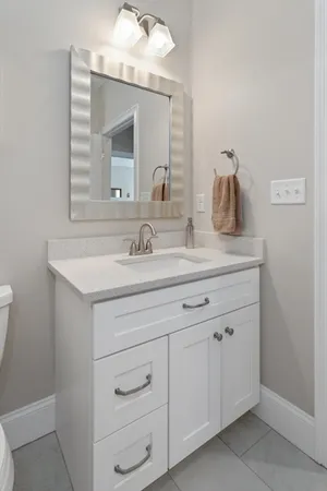 a bathroom with a sink vanity and mirror