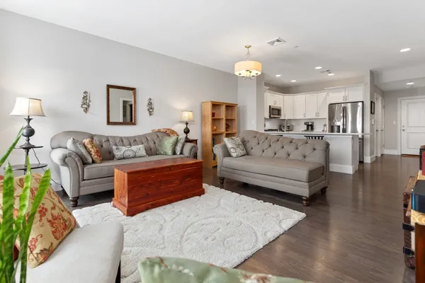 a spacious bedroom with a bed a couch and dresser