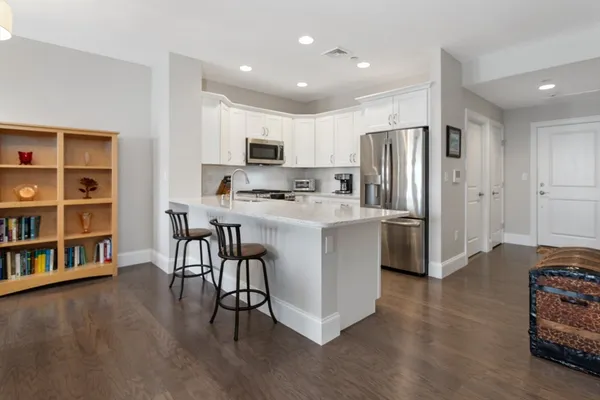a kitchen with stainless steel appliances a refrigerator and a stove top oven