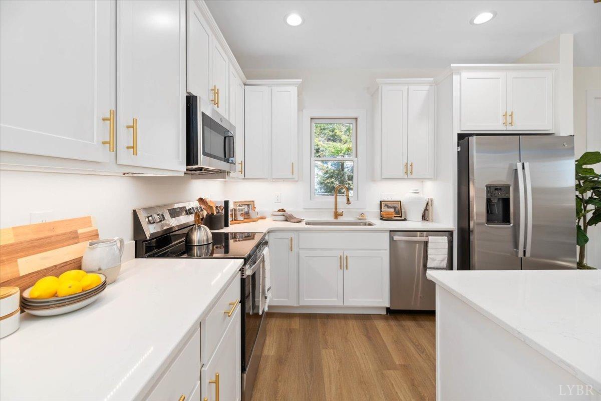 1101 Harrison Street Lynchburg, VA 24504 - Photo 17 of 66 a kitchen with a sink a stove and a refrigerator