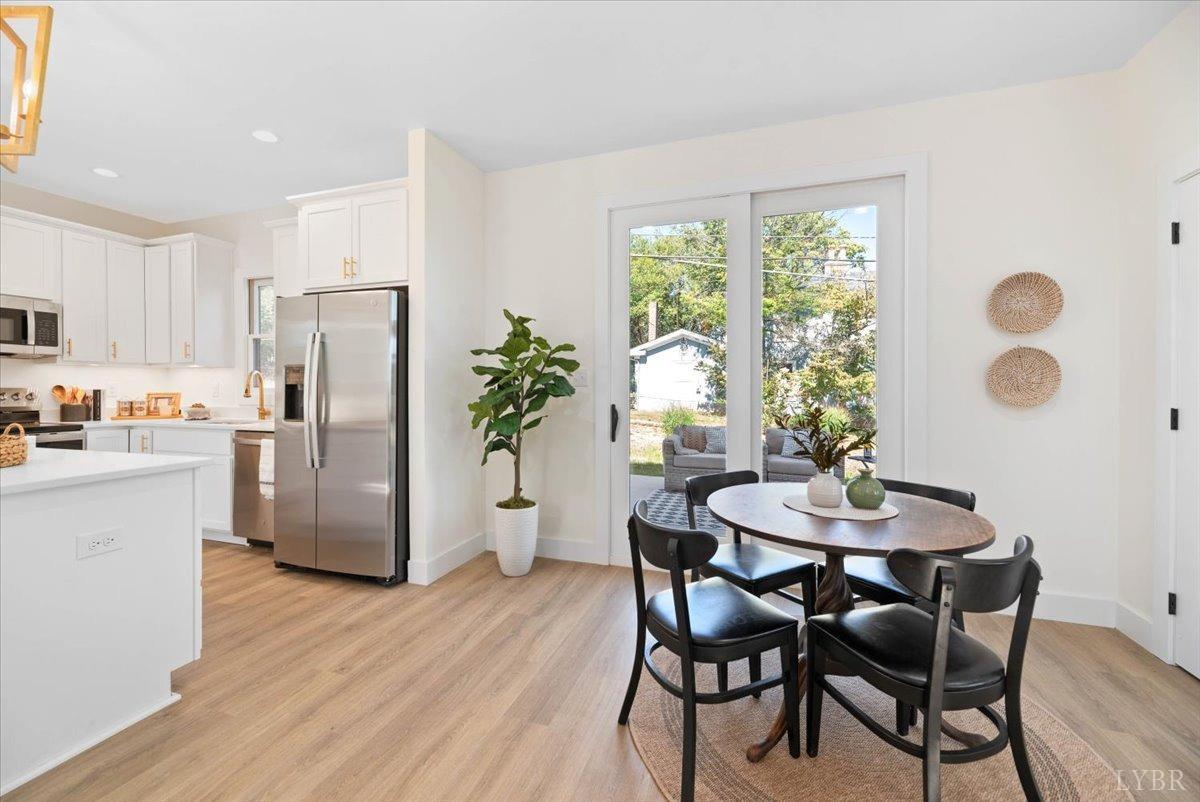 1101 Harrison Street Lynchburg, VA 24504 - Photo 25 of 66 a kitchen with refrigerator and wooden floor