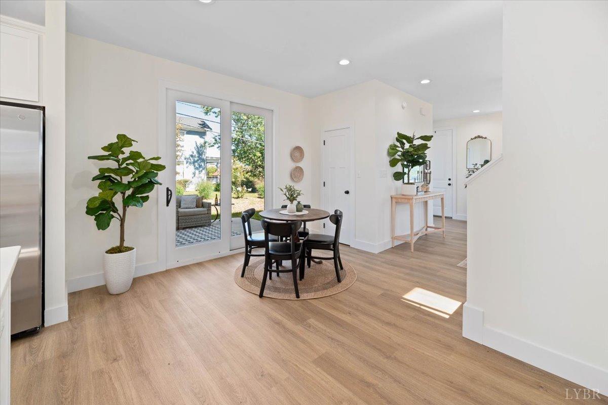 1101 Harrison Street Lynchburg, VA 24504 - Photo 27 of 66 a dining room with furniture potted plants and wooden floor