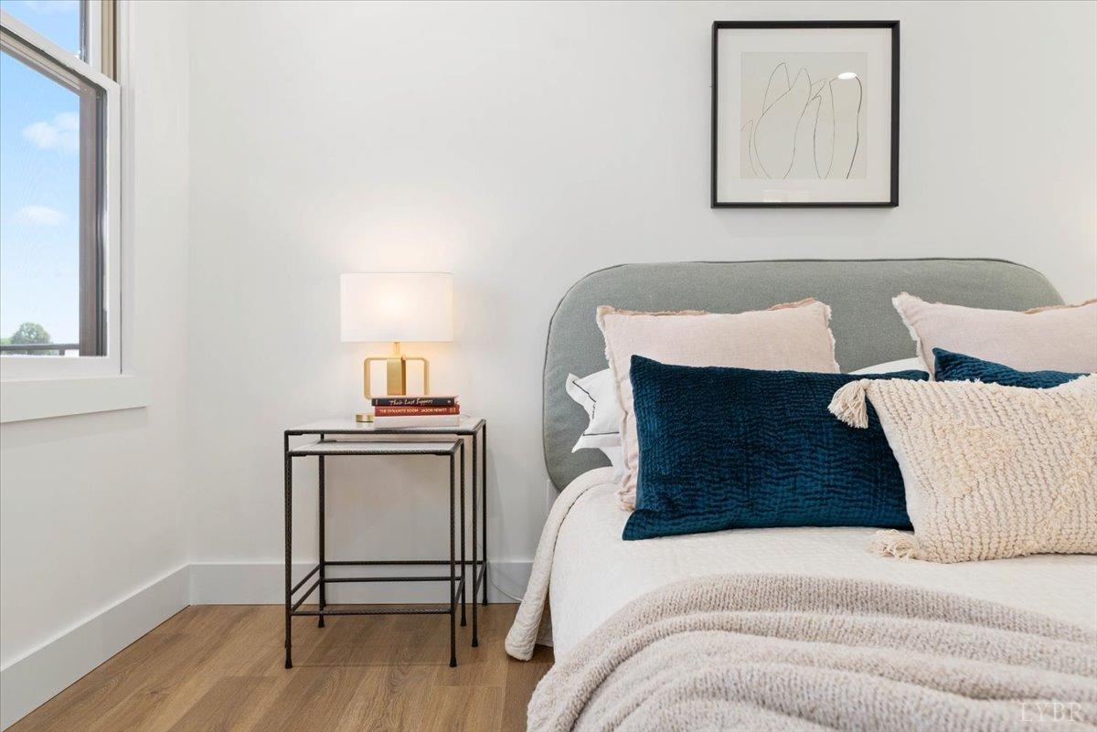 1101 Harrison Street Lynchburg, VA 24504 - Photo 35 of 66 a bedroom with a bed and a lamp on table