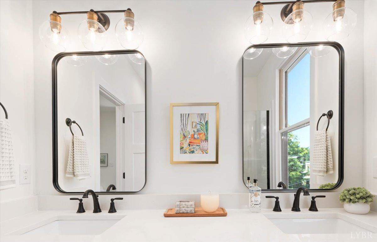 1101 Harrison Street Lynchburg, VA 24504 - Photo 45 of 66 a bathroom with a double vanity sink and a mirror