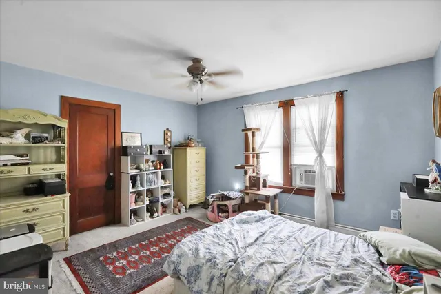 a bedroom with a bed a dresser and book shelf