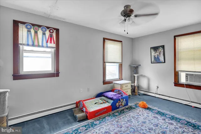 a bedroom with furniture and a window