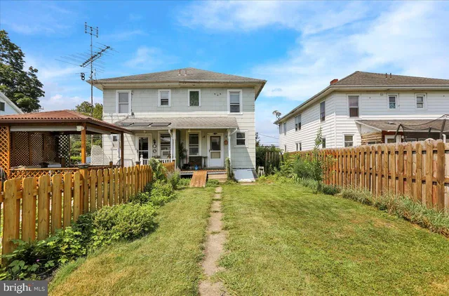 a front view of a house with a yard table and chairs