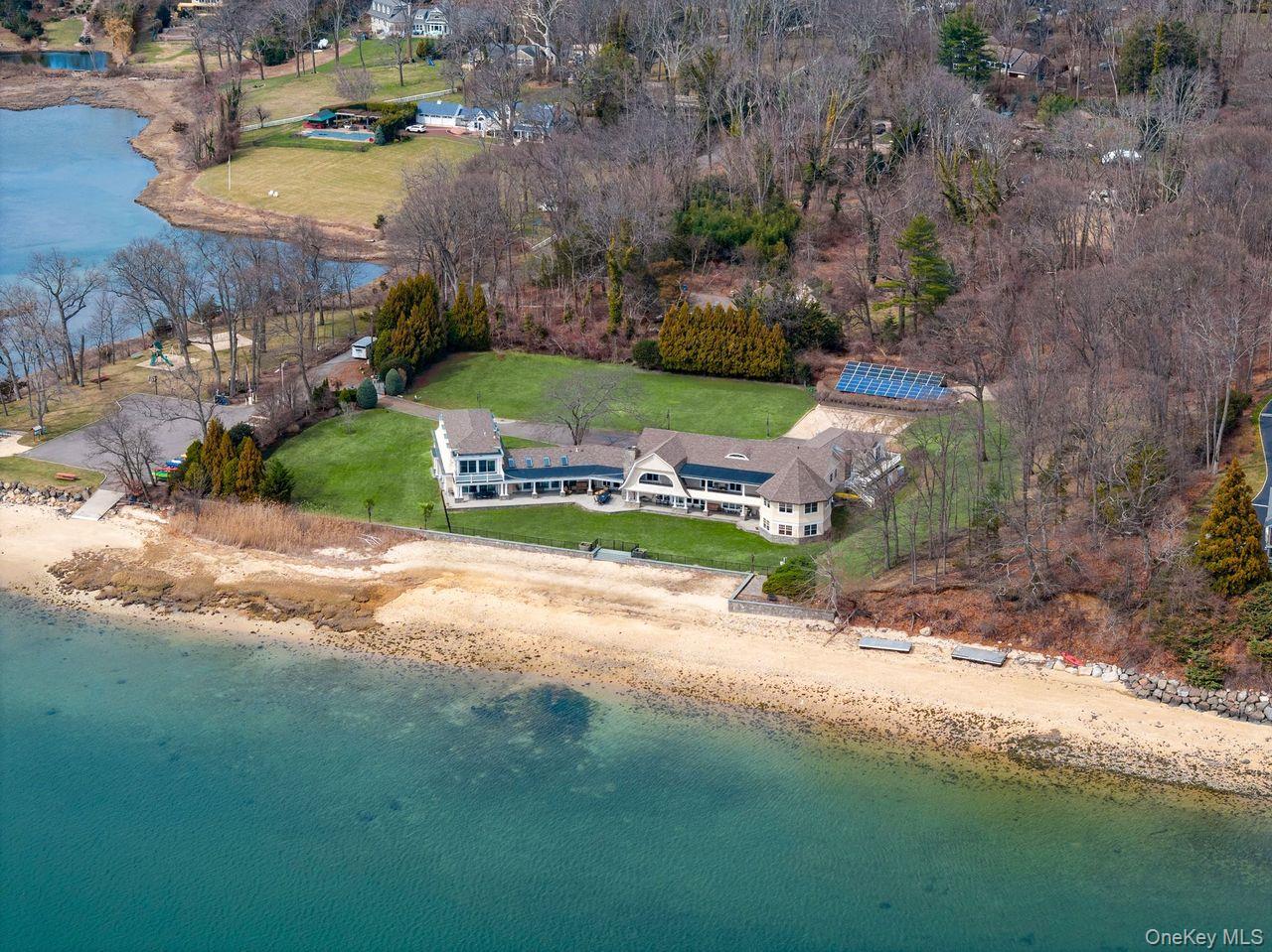 33 Beach Road Northport, NY 11768 - Photo 47 of 50 an aerial view of a house with a yard and lake
