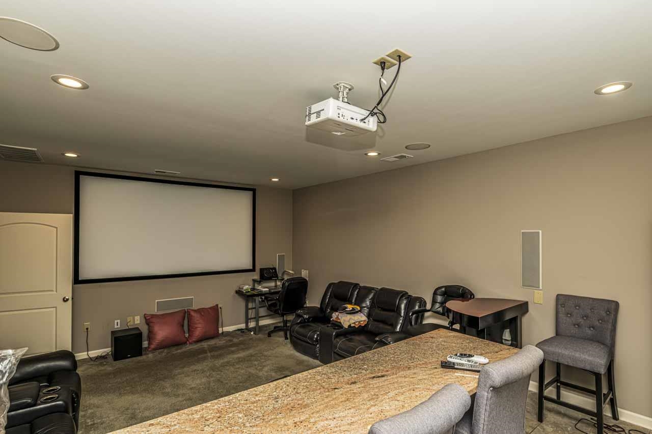 185 Belmont Road Mason, TN 38049 - Photo 27 of 38 Dedicated media room featuring a large projection screen and ceiling-mounted projector
