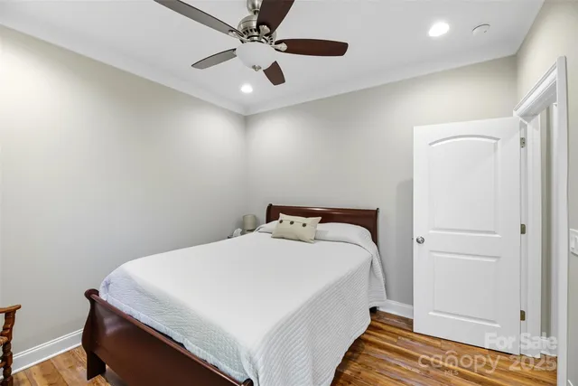a bedroom with a bed and a ceiling fan