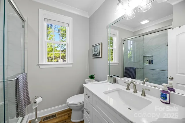 a bathroom with a sink vanity granite and toilet