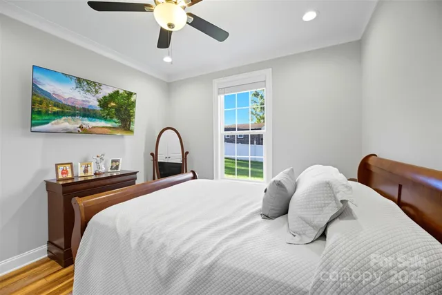 a bedroom with a bed and a large window