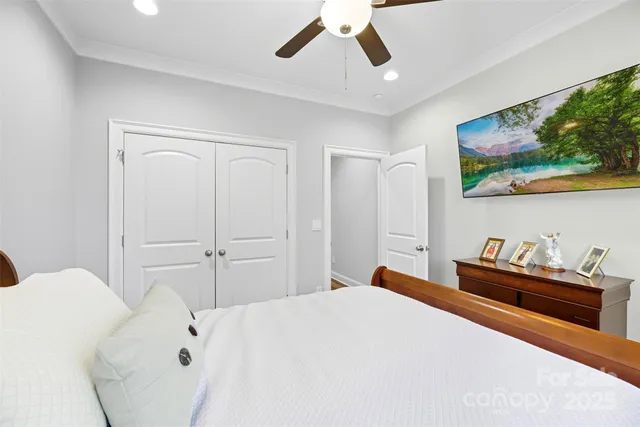 a bedroom with a bed and a chandelier