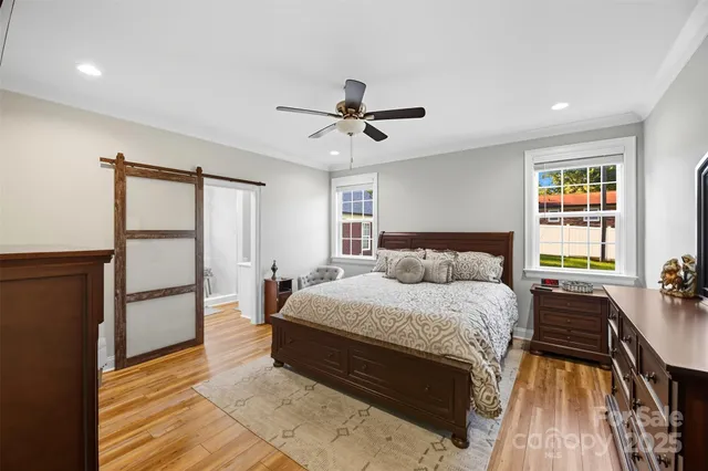 a spacious bedroom with a bed and a chandelier