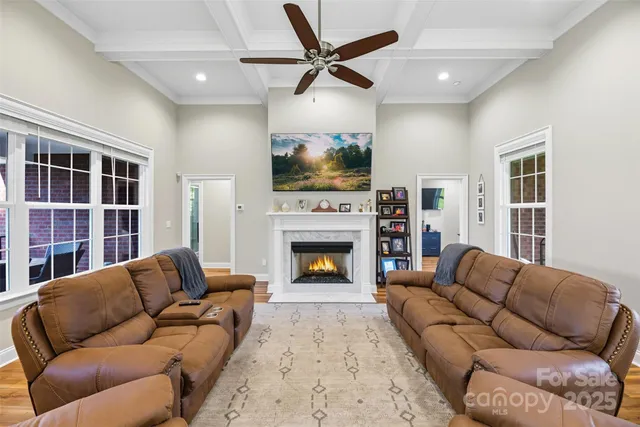 a living room with furniture ceiling fan and a fireplace