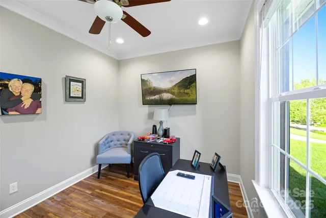 a view of a workspace with furniture and a window