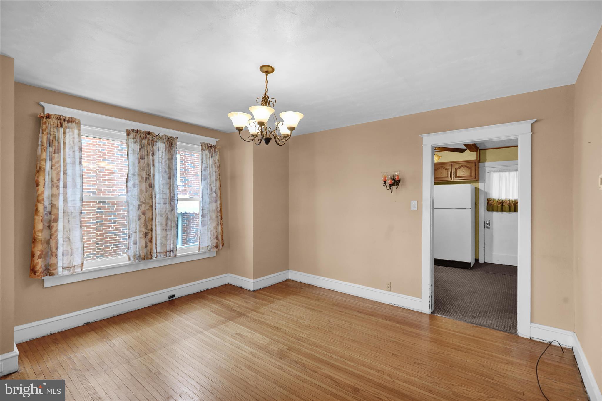 1522 Delaware Avenue Reading, PA 19610 - Photo 5 of 39 a view of an empty room with wooden floor and a window