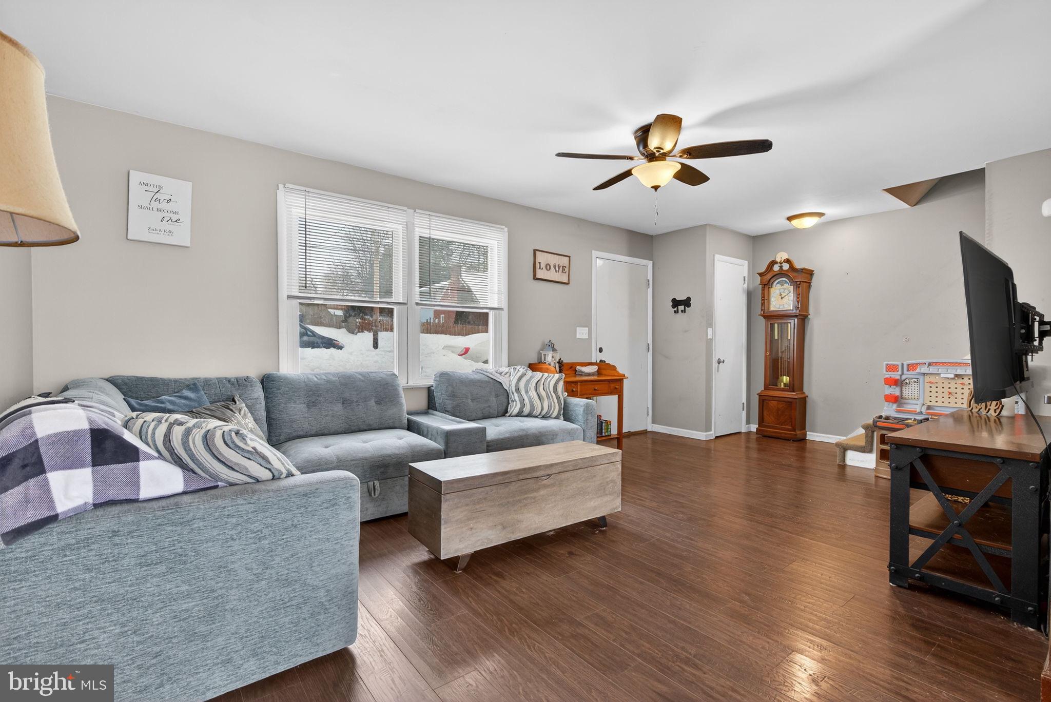 311 Fulton Street Akron, PA 17501 - Photo 13 of 30 a living room with furniture a ceiling fan and a flat screen tv
