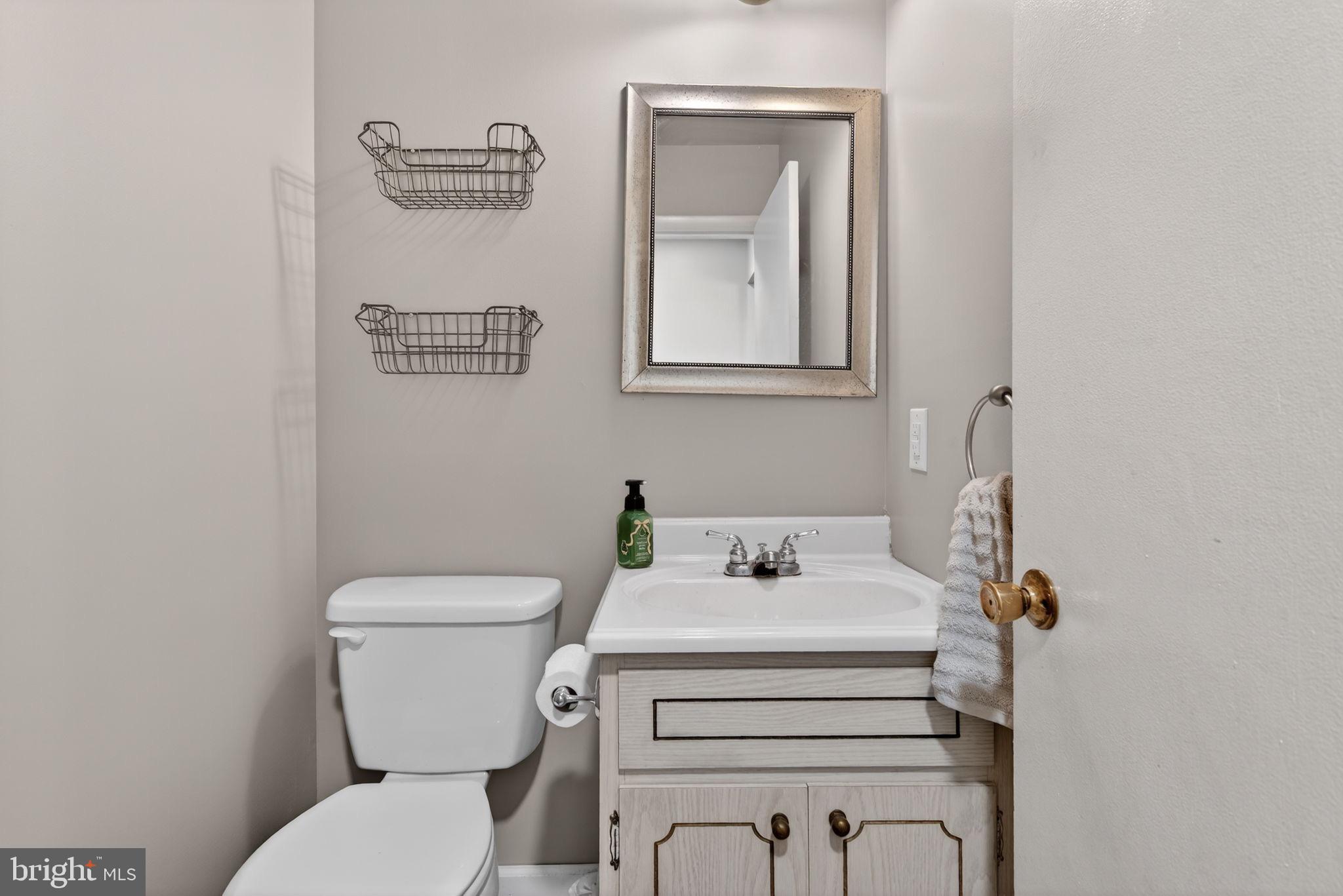 311 Fulton Street Akron, PA 17501 - Photo 14 of 30 a bathroom with a toilet sink and mirror
