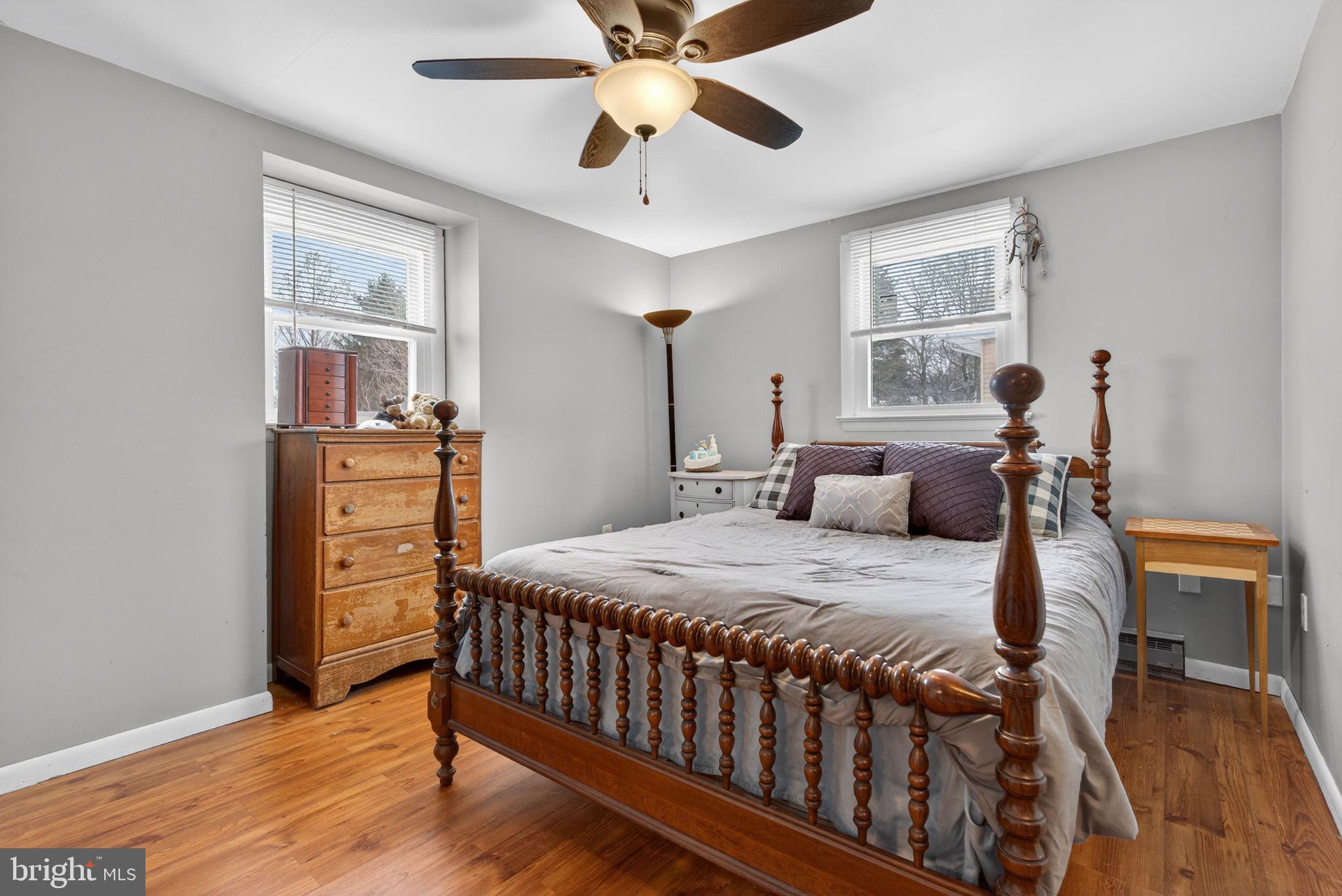 311 Fulton Street Akron, PA 17501 - Photo 15 of 30 a bedroom with a bed and wooden floor