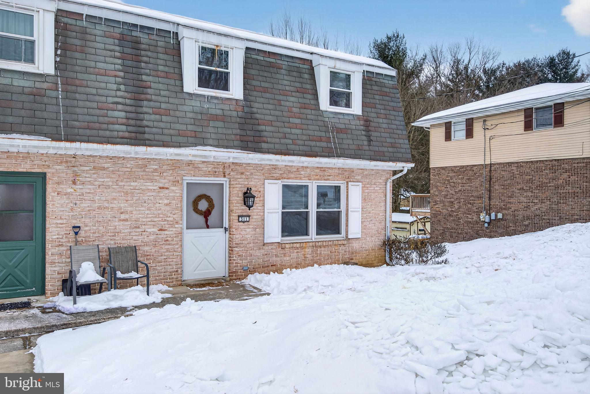 311 Fulton Street Akron, PA 17501 - Photo 2 of 30 a front view of a house with a yard and garage