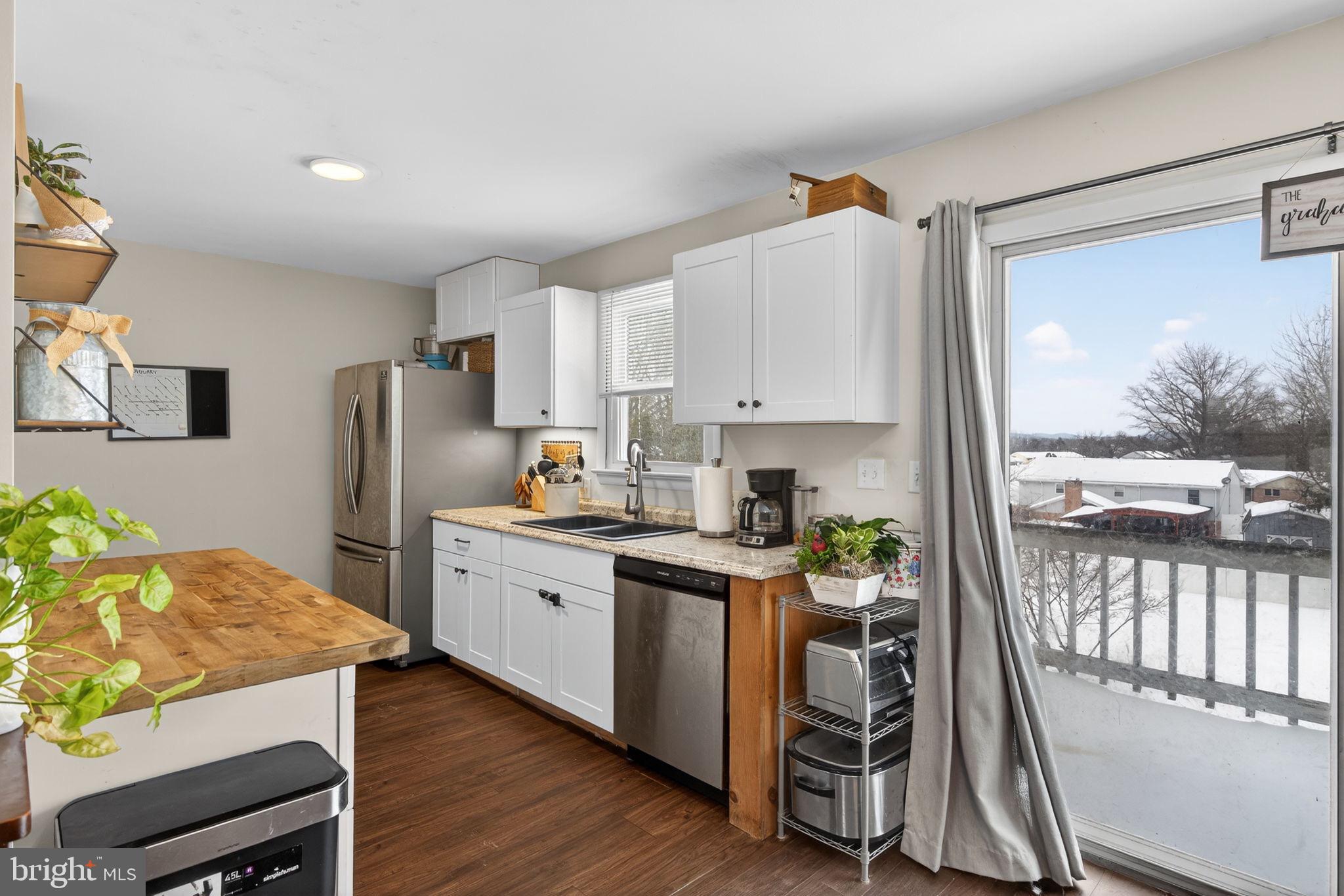 311 Fulton Street Akron, PA 17501 - Photo 3 of 30 a kitchen with refrigerator cabinets and wooden floor
