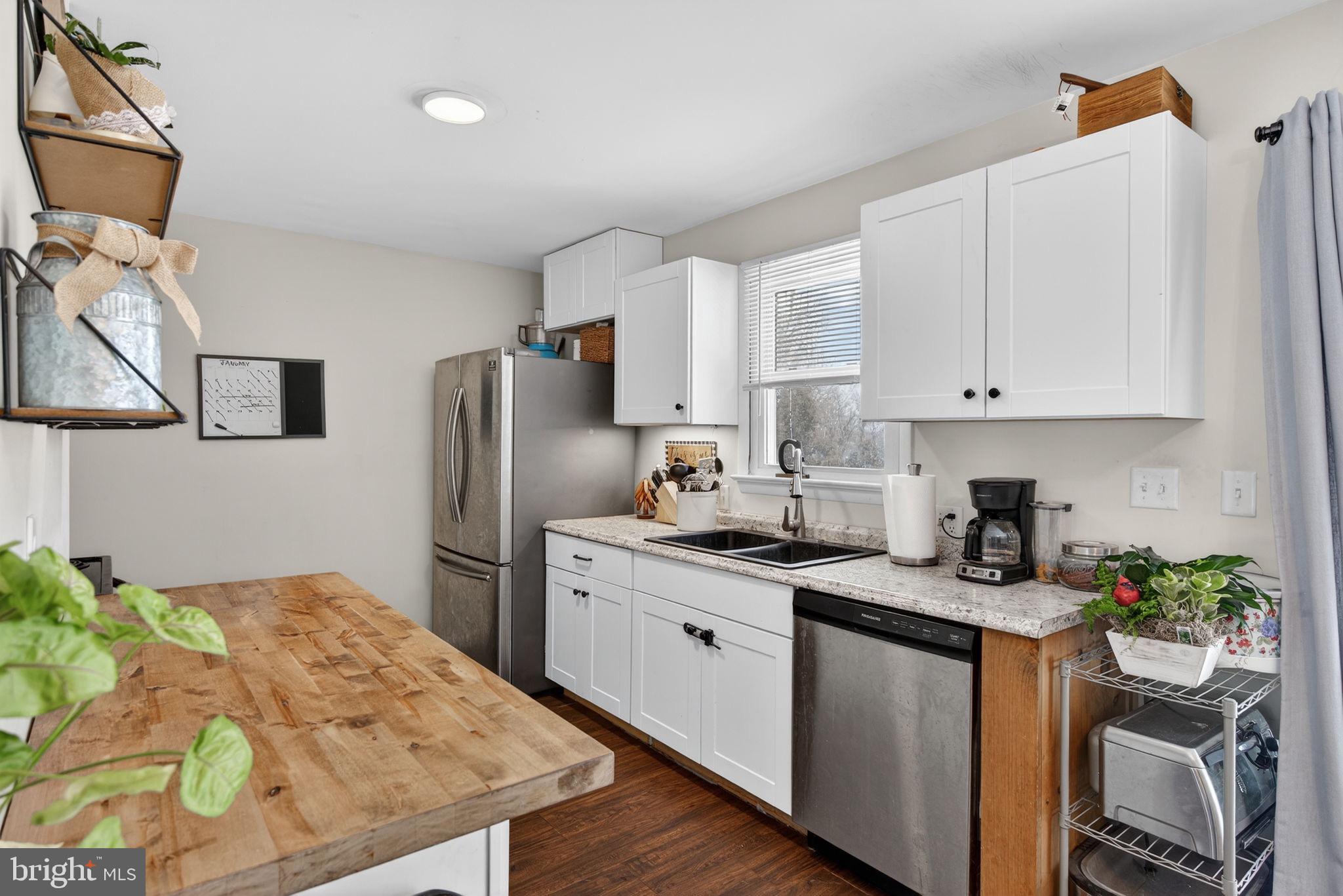 311 Fulton Street Akron, PA 17501 - Photo 5 of 30 a kitchen with stainless steel appliances granite countertop a sink a stove a refrigerator a center island and cabinets