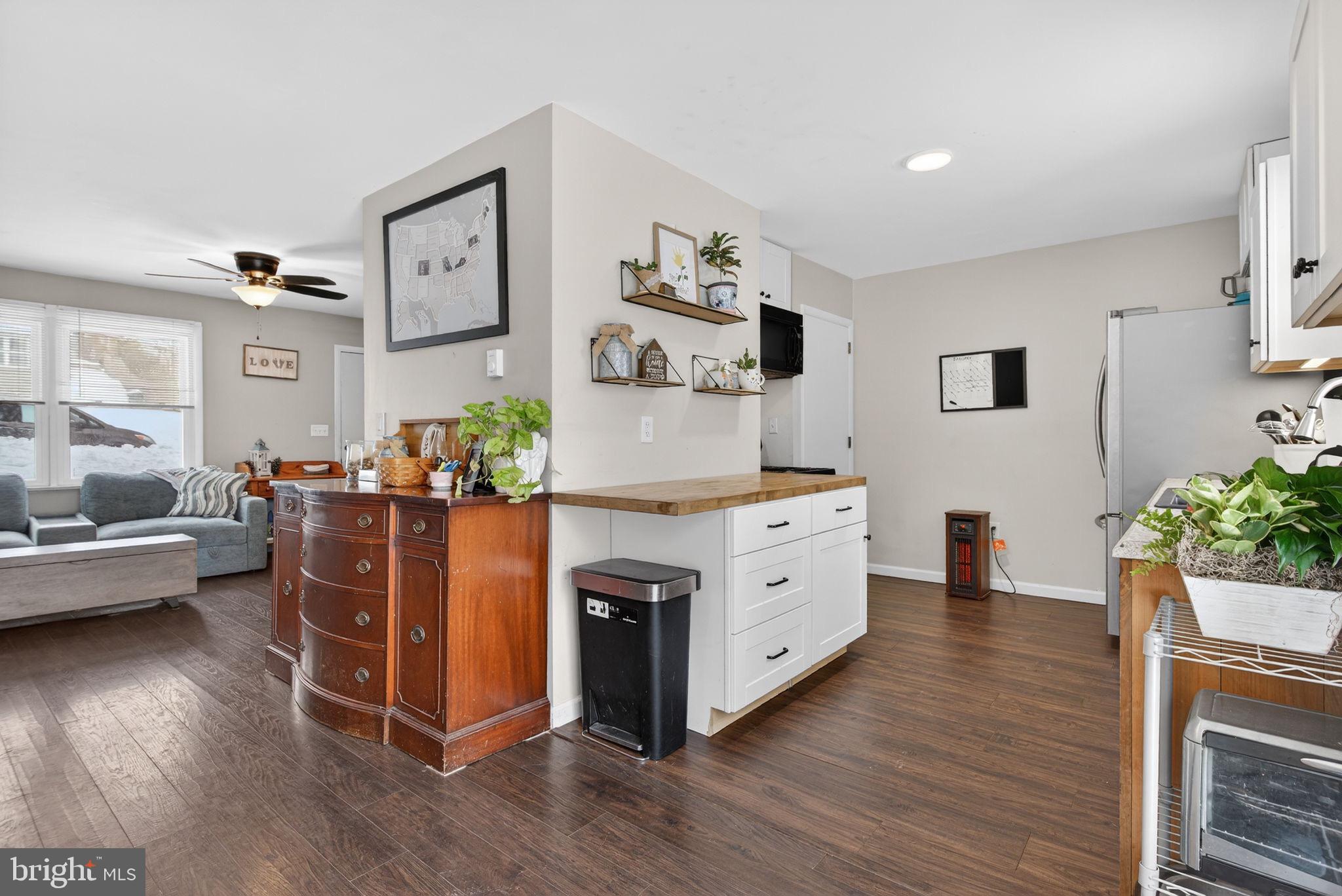311 Fulton Street Akron, PA 17501 - Photo 7 of 30 a kitchen with stainless steel appliances a stove and wooden floor