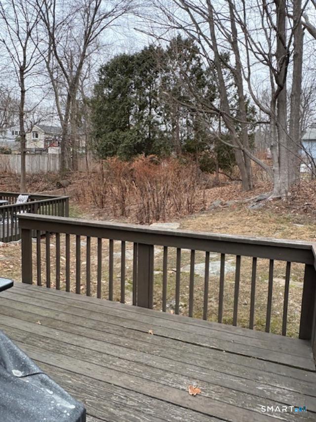 128 Lyman Road, Unit 24 Wolcott, CT 06716 - Photo 2 of 13 a balcony with wooden floor and fence
