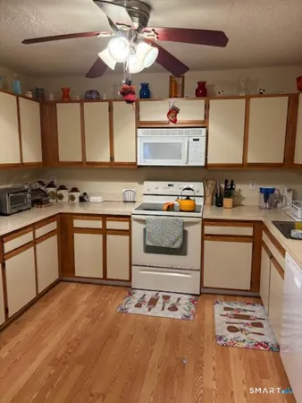 a kitchen with a stove a sink and a microwave