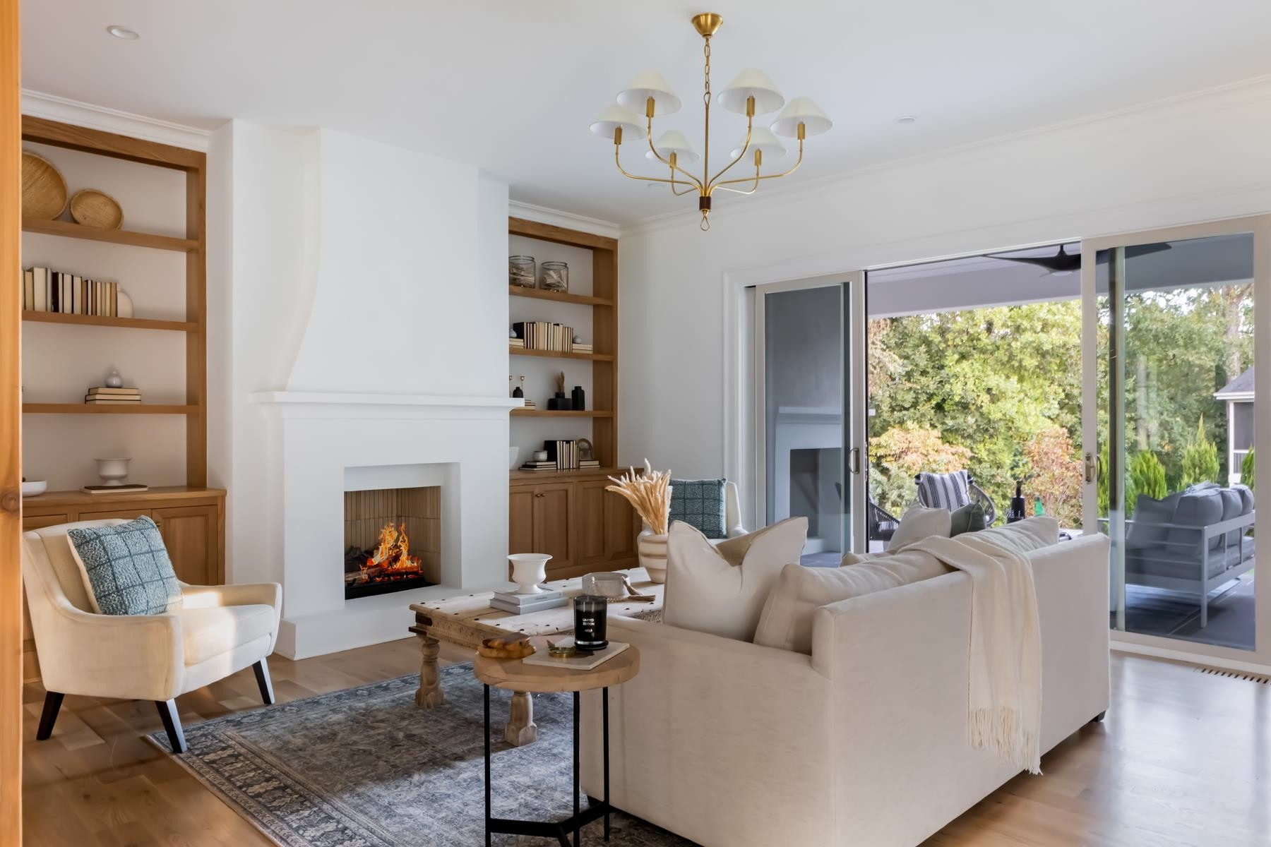 727 Lake Boone Trail Raleigh, NC 27607 - Photo 13 of 100 a living room with furniture a fireplace and a chandelier