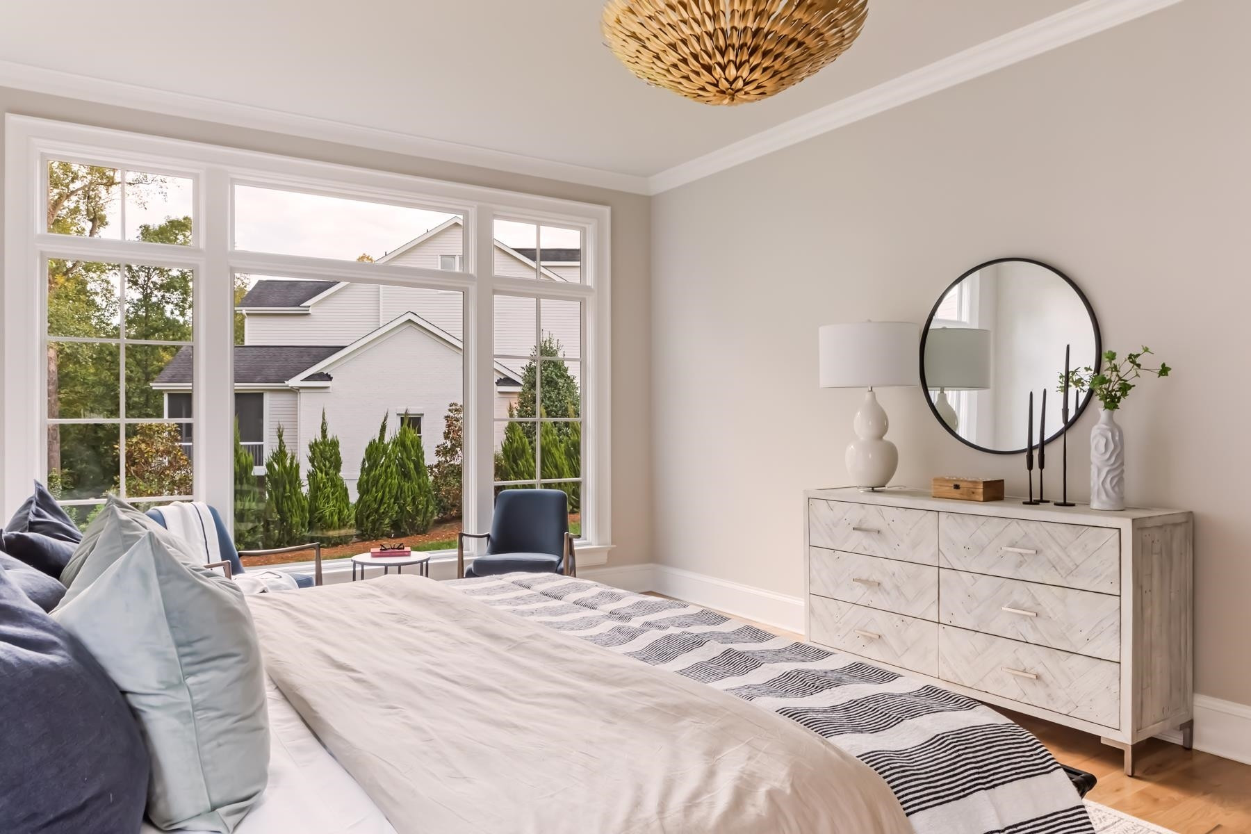 727 Lake Boone Trail Raleigh, NC 27607 - Photo 39 of 100 a bedroom with a bed a mirror and a large window