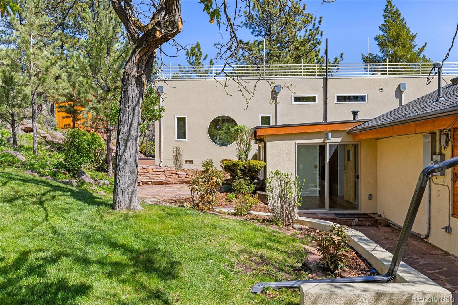 1669 Apple Valley Road Lyons, CO 80540 - Photo 12 of 48 a view of a wooden house with a bench and plants