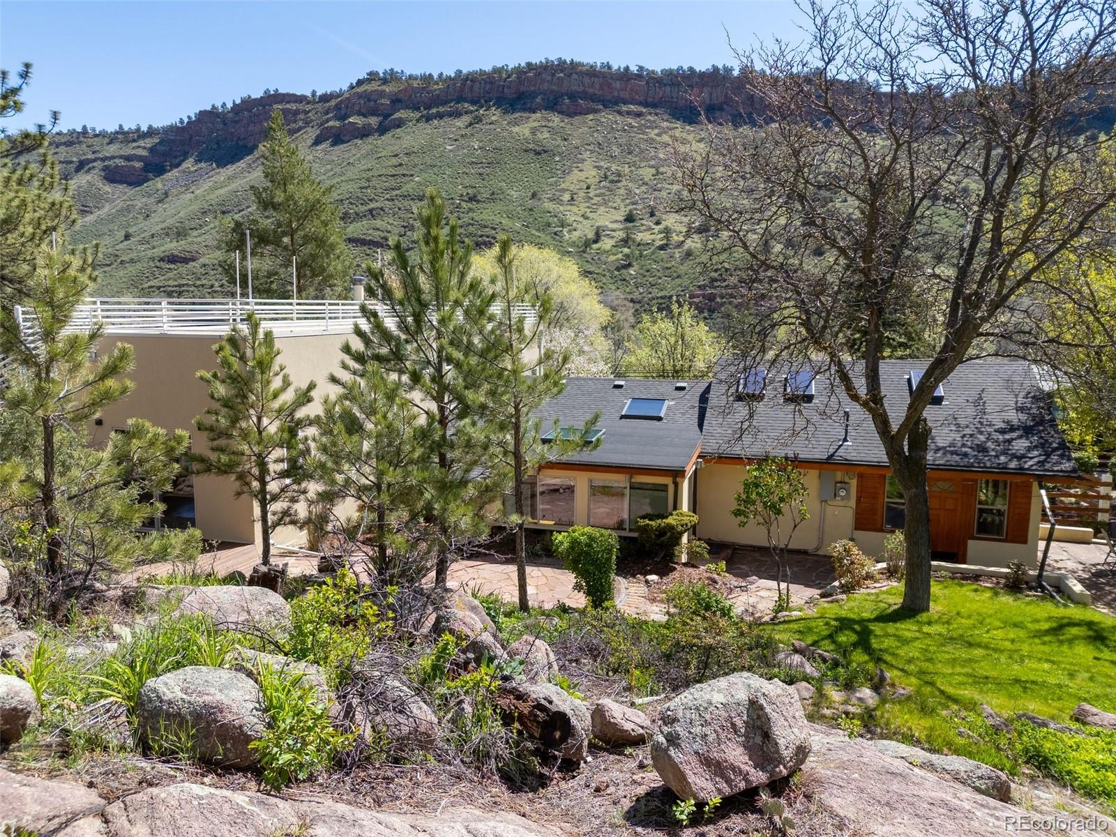 1669 Apple Valley Road Lyons, CO 80540 - Photo 14 of 48 a front view of a house with a yard and large tree