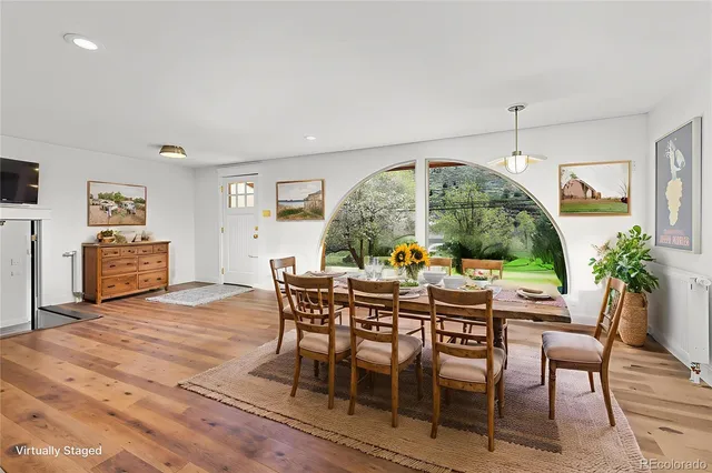 a view of a dining room with furniture window and wooden floor