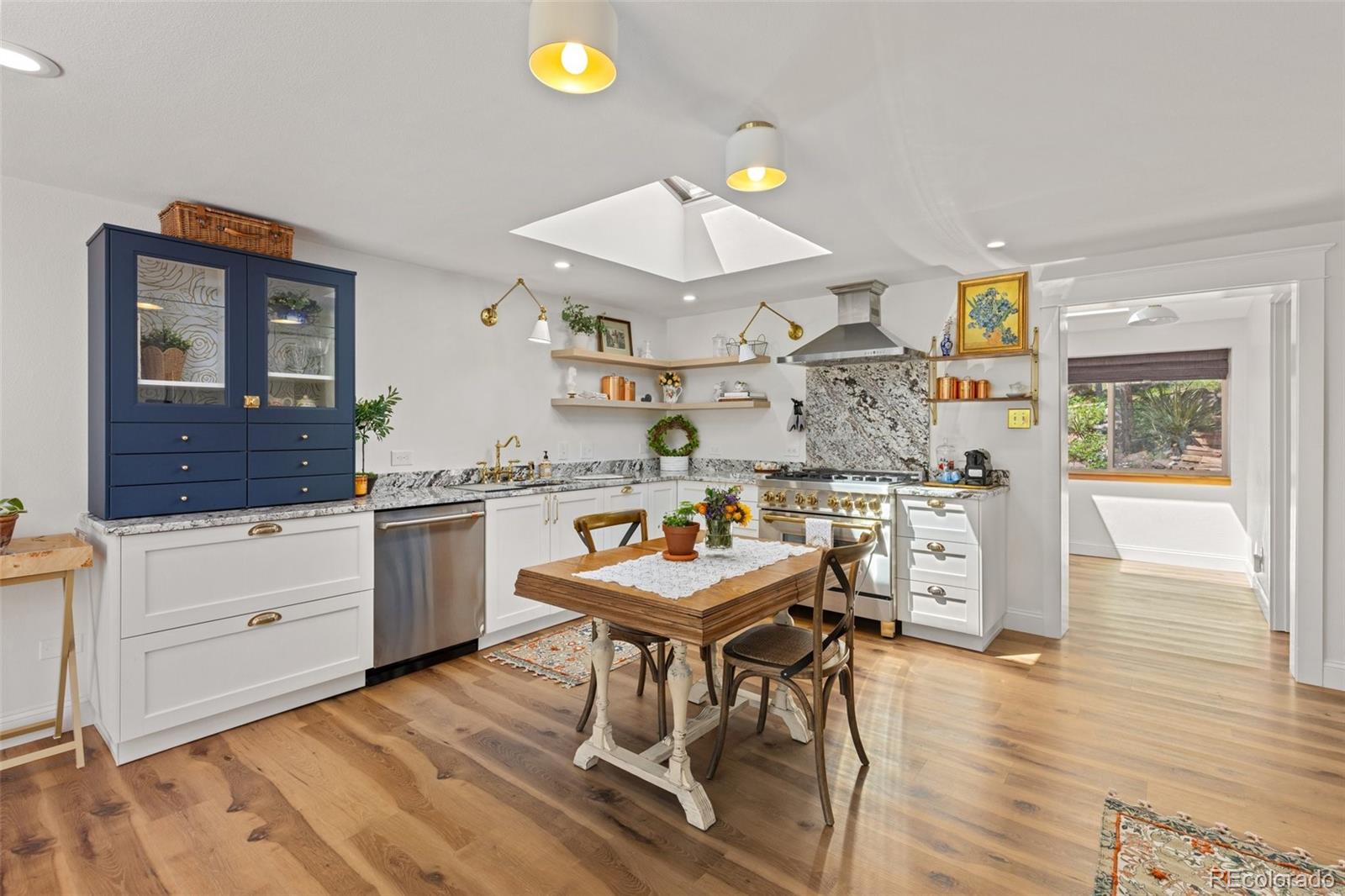 1669 Apple Valley Road Lyons, CO 80540 - Photo 22 of 48 a room with stainless steel appliances kitchen island granite countertop a table chairs and a stove