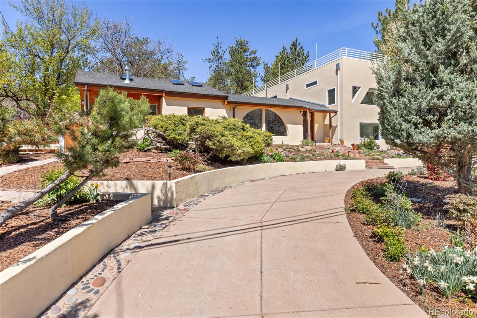 1669 Apple Valley Road Lyons, CO 80540 - Photo 3 of 48 a front view of a house with a yard and potted plants