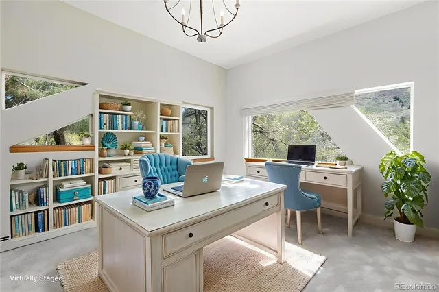 a view of a workspace with furniture and a potted plant