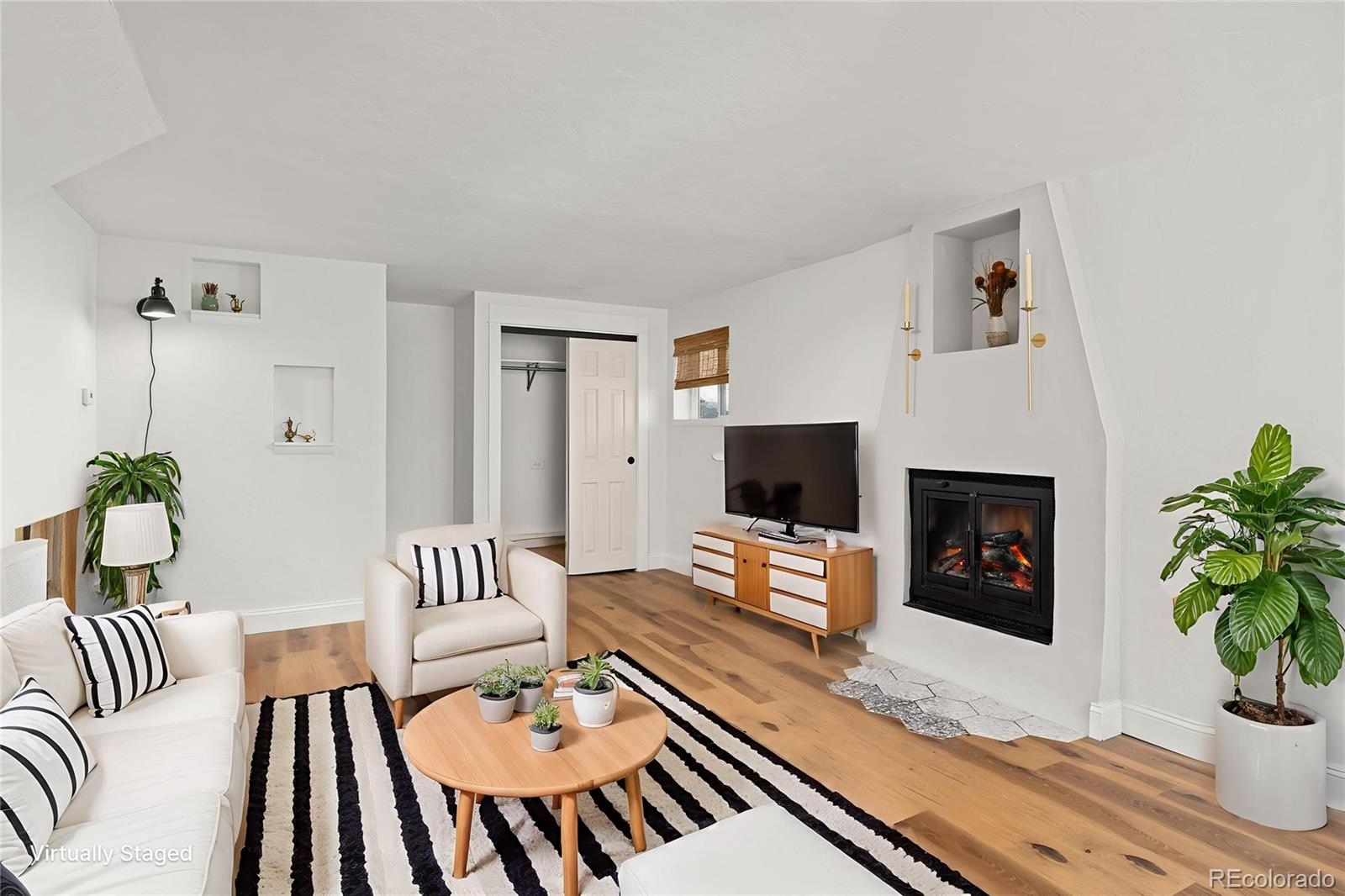 1669 Apple Valley Road Lyons, CO 80540 - Photo 46 of 48 a living room with furniture a fireplace and a potted plant