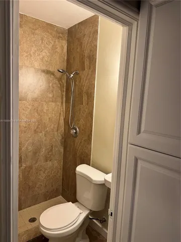 a bathroom with a toilet a sink and shower