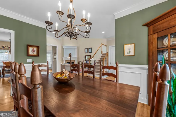 a view of a dining room with furniture wooden floor and chandelier