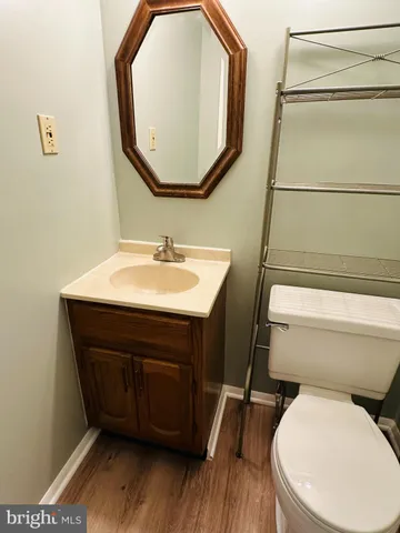 a bathroom with a toilet a sink and a mirror